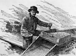 Historical illustration of a gold prospector using a sluice box and pan, 1800s style