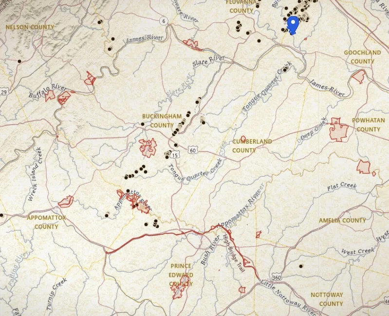 VaGoldMaps full-screen map over Buckingham and Fluvanna Counties: USGS topo, blue drainages, historic mine ticks along the Gold-Pyrite Belt, red park and WMA boundaries, and a saved-place pin.